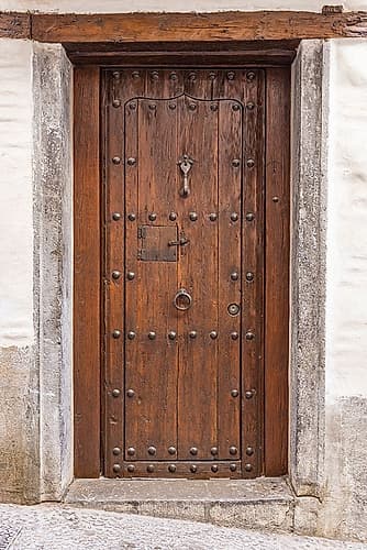 Albaicin, Province of Granada, Andalusia, Spain. An old wooden door on a building. Art Print